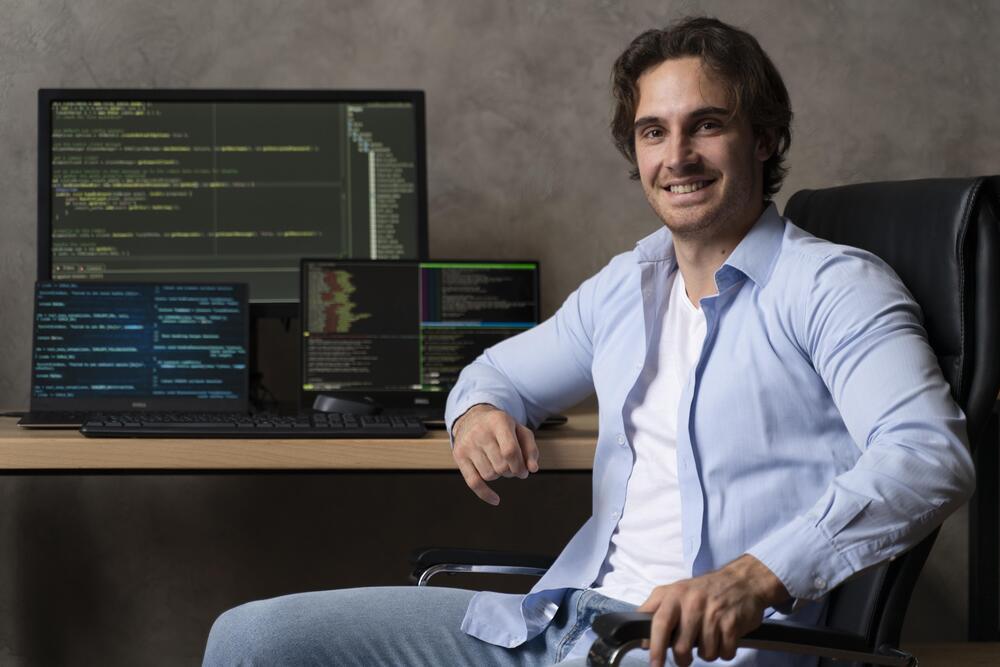 medium-shot-programmer-sitting-o-3