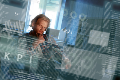 Young concentrated computer developer writing new code